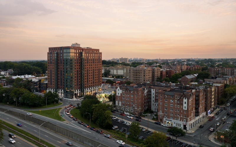 aerial view of city with highway and buildings at dusk