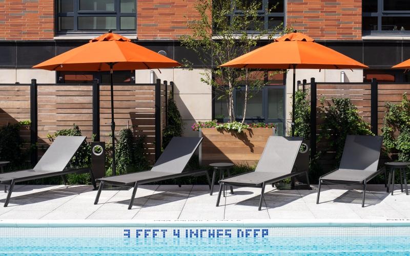 a pool with chairs and umbrellas